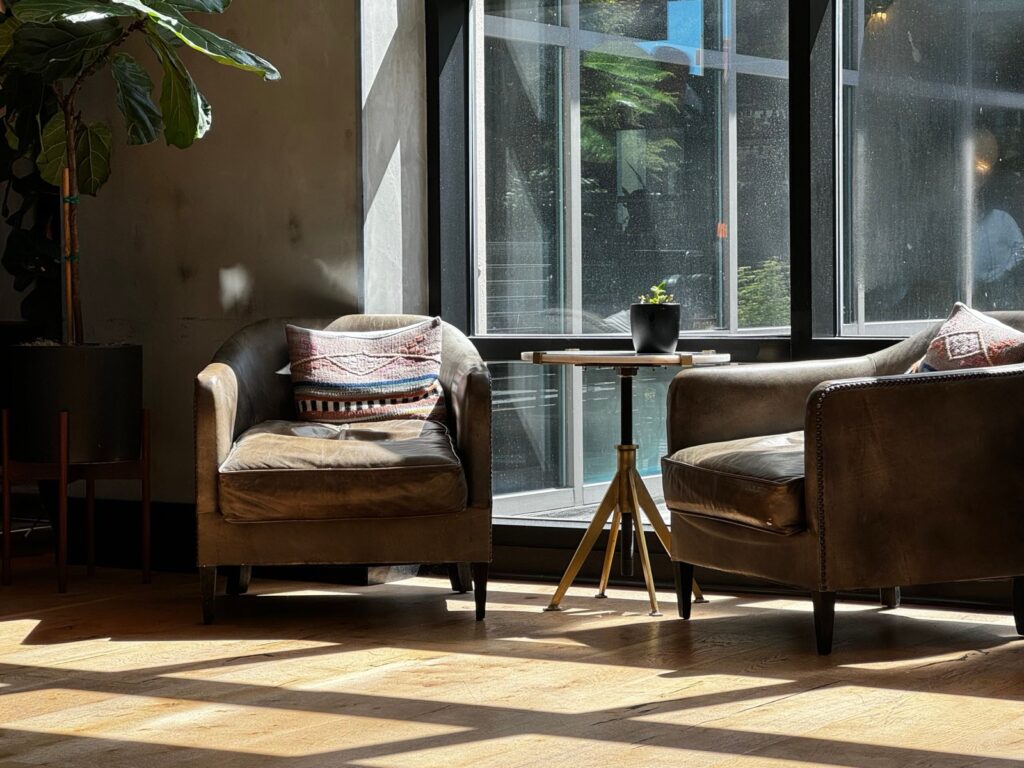 A calm seating corner with two armchairs by a sunlit window